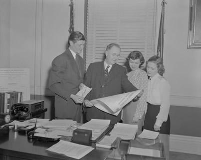 Dr. Herman Lee Donovan (2nd from left) reviews the 4-H Club Calendar of Events with Club President Dale Stahlg (Warren Co.), Vice President Doris Clifford (Harris Co), and Secretary Betty Sue Cornett (Clay County).